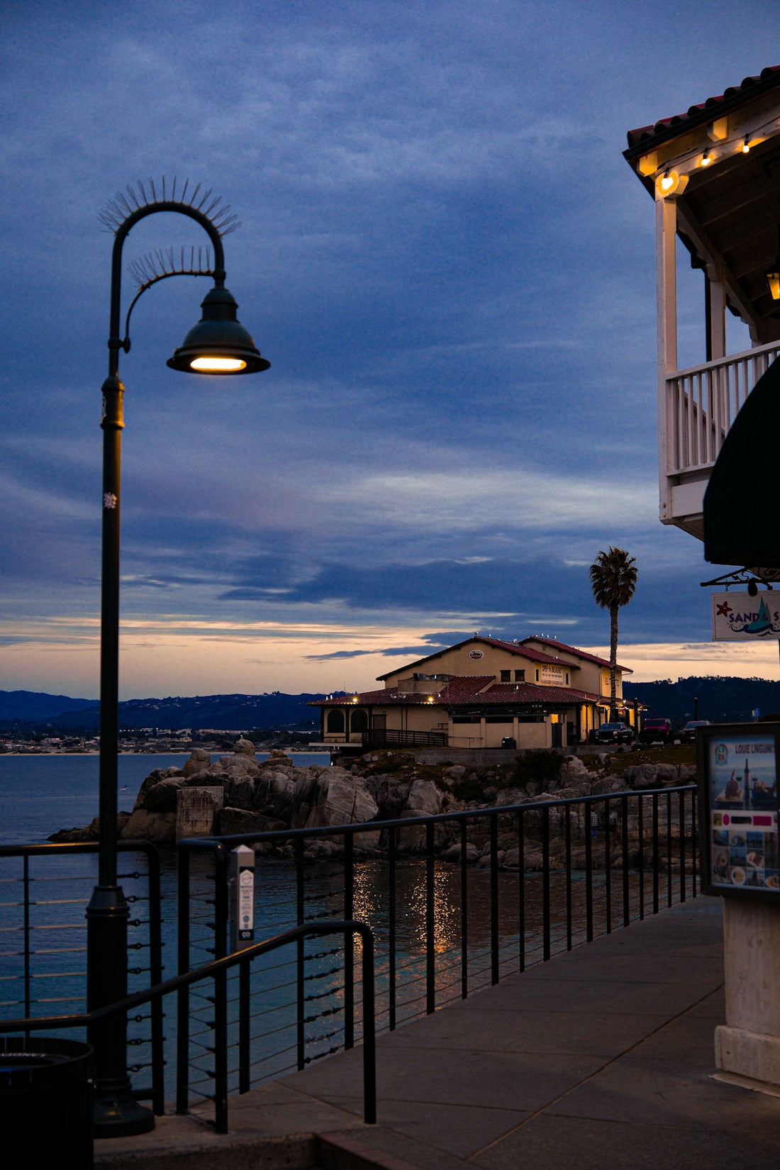Coastal building with a street lamp at dusk